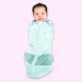 Baby swaddled in teal planets Sleepea 