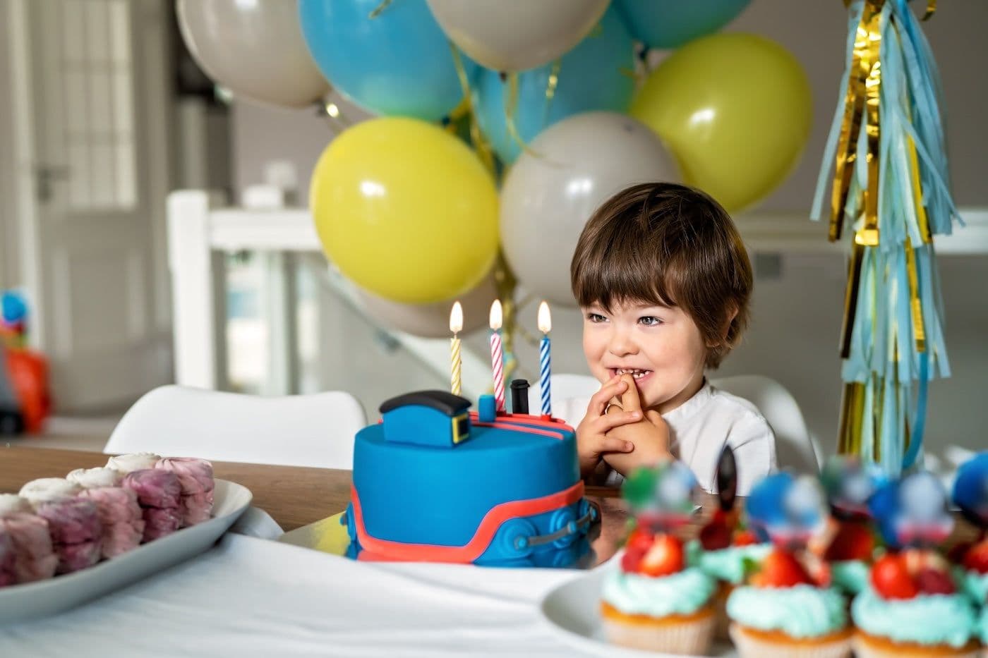 3-year-old boy gets ready to blow out his birthday candles