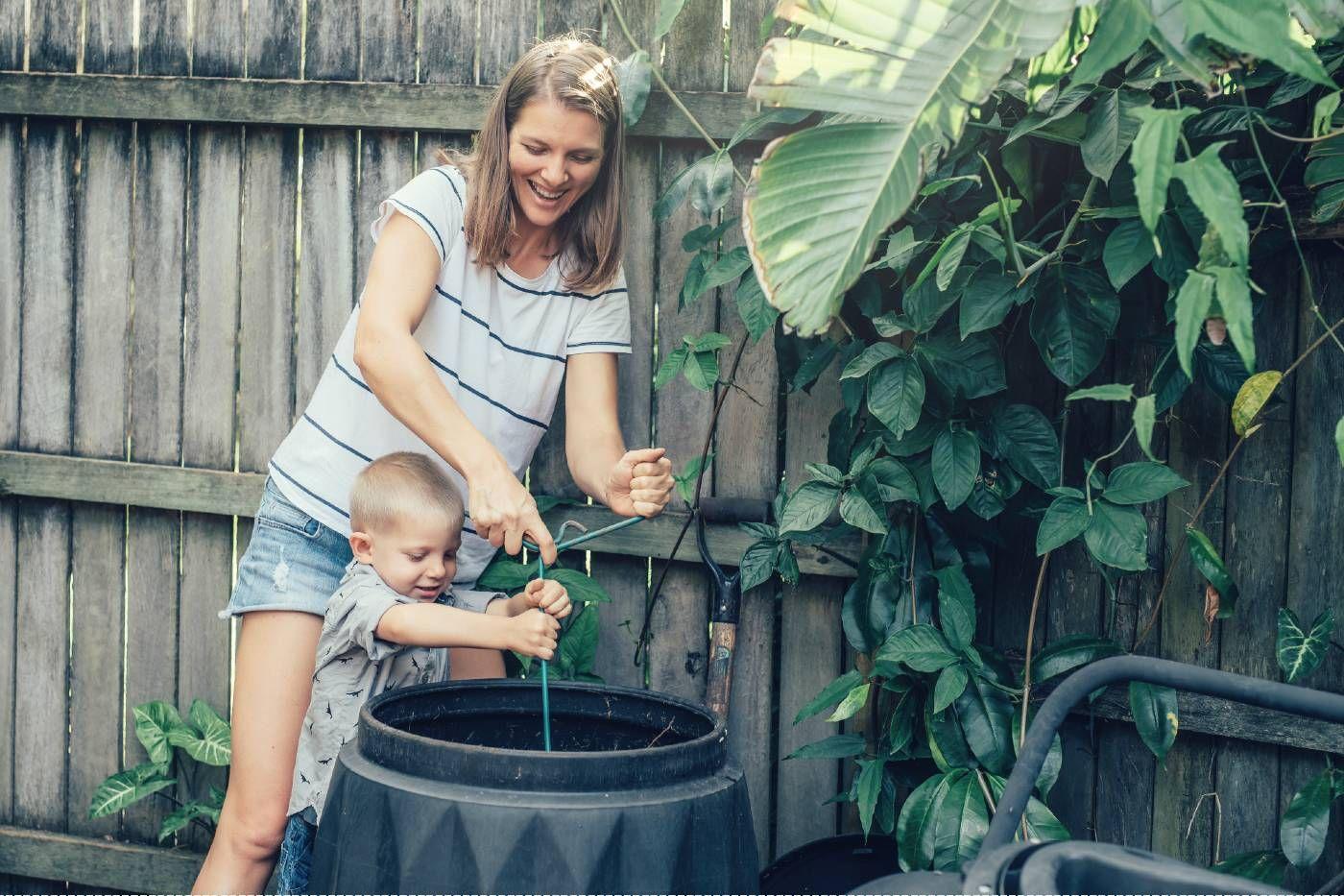A mother composts with her young son