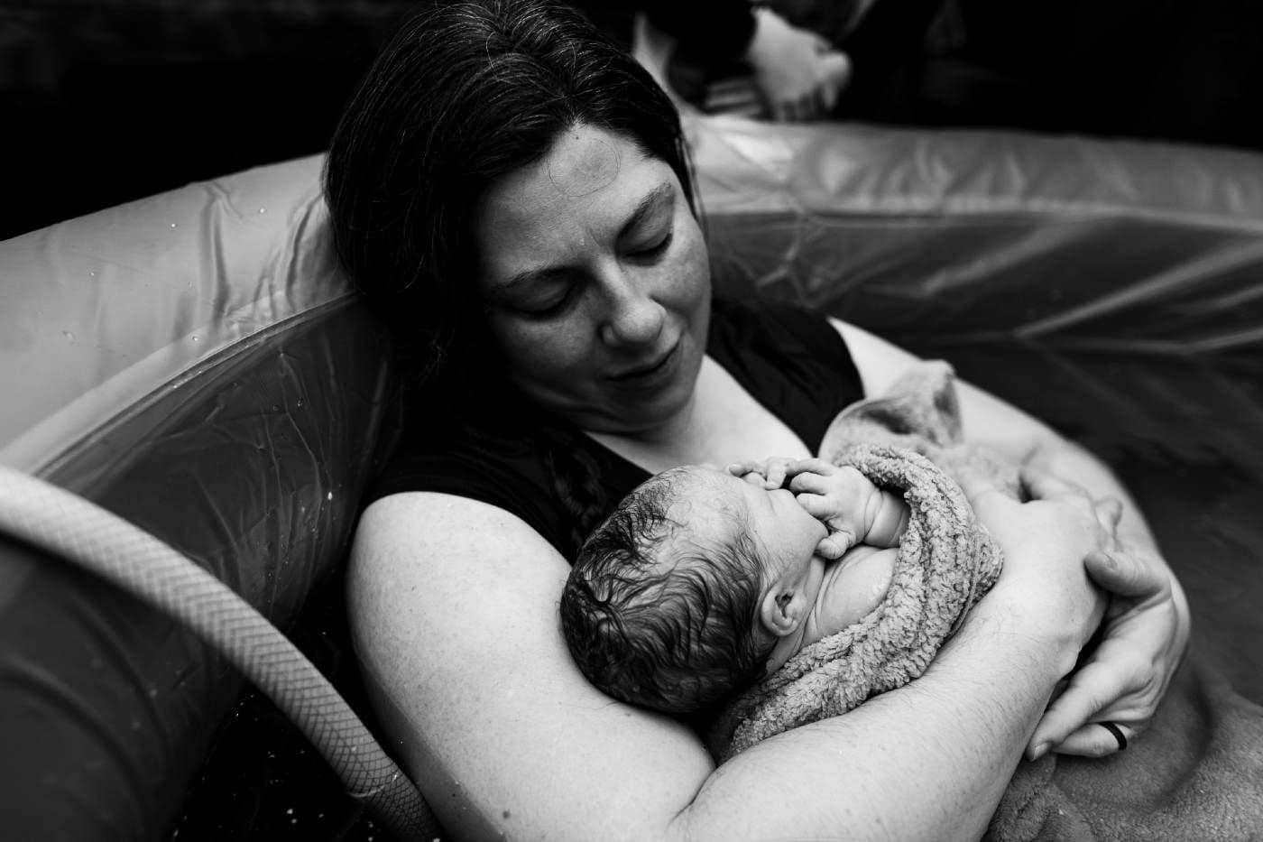 SNOO story: Victoria David - mother cradling baby after homebirth