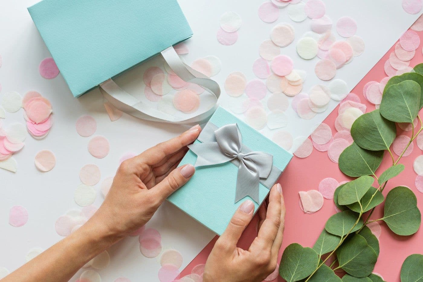 A woman holds a pregnancy announcement gift