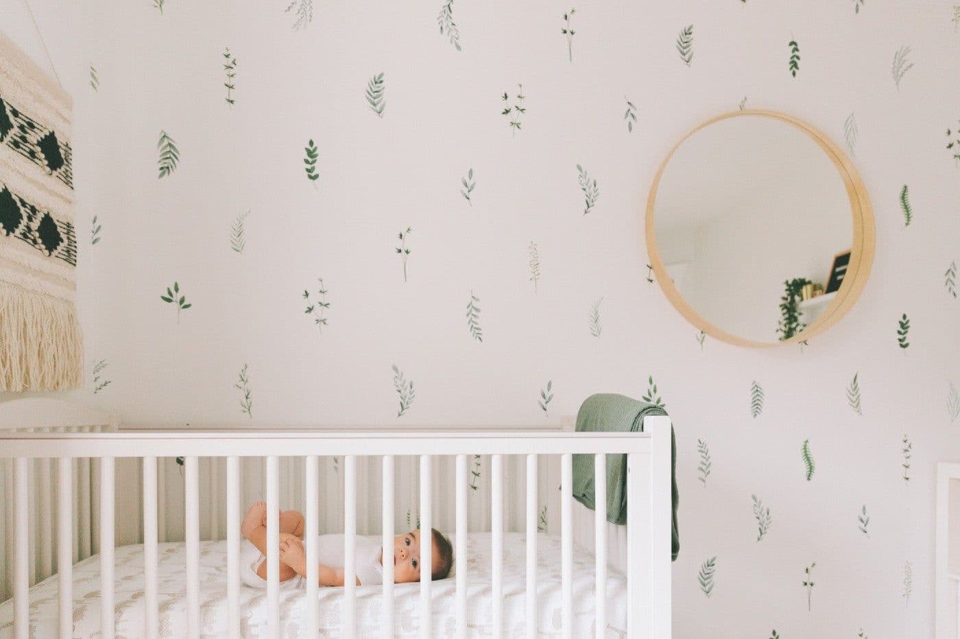 baby-in-nursery-with-nature-wallpaper