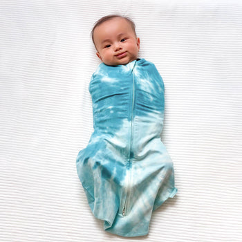 Baby swaddled in blue tie-dye Sleepea