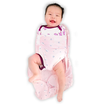 Happy baby in unzipped rose planets Sleepea with arms swaddled down